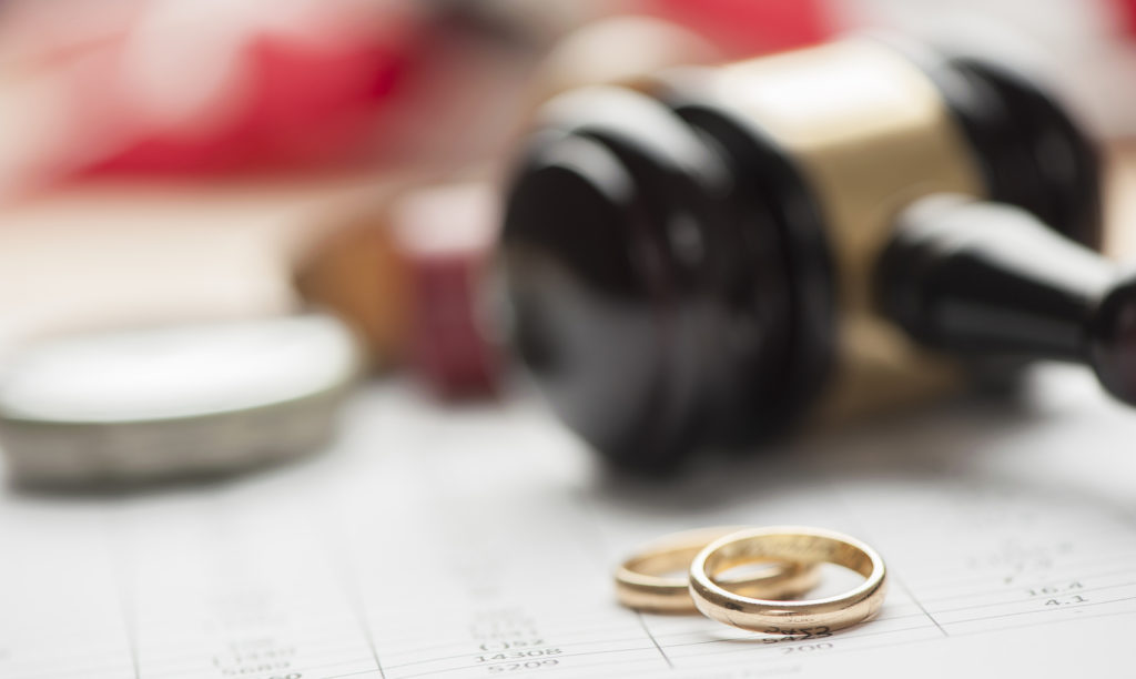 Gavel and wedding rings Gavel and wedding rings for divorce concept